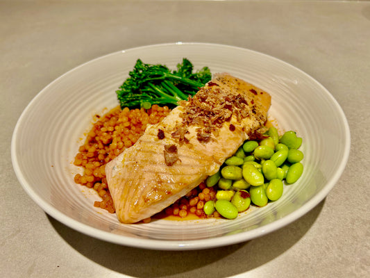 Salmon with tomato couscous in broth