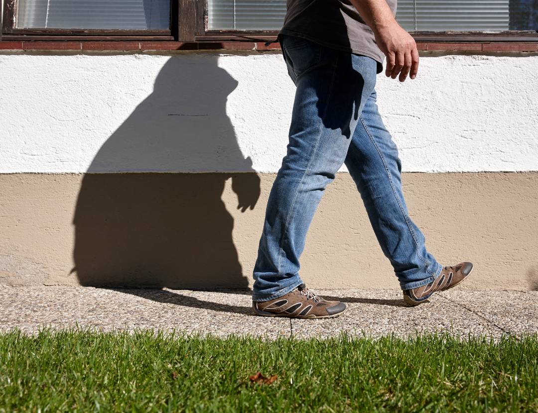 A close-up image of a mans legs while he's walking 