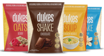 4 bags of Dukes Weight Loss Shakes standing up side by side, including berry, chocolate, chicken and vanilla flavours. 