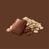 A square of chocolate and a pile of oats on a brown background 