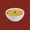 A bowl of beef and vegetable soup on a dark red background 