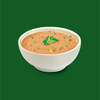 A bowl of mild curry soup on a green background 